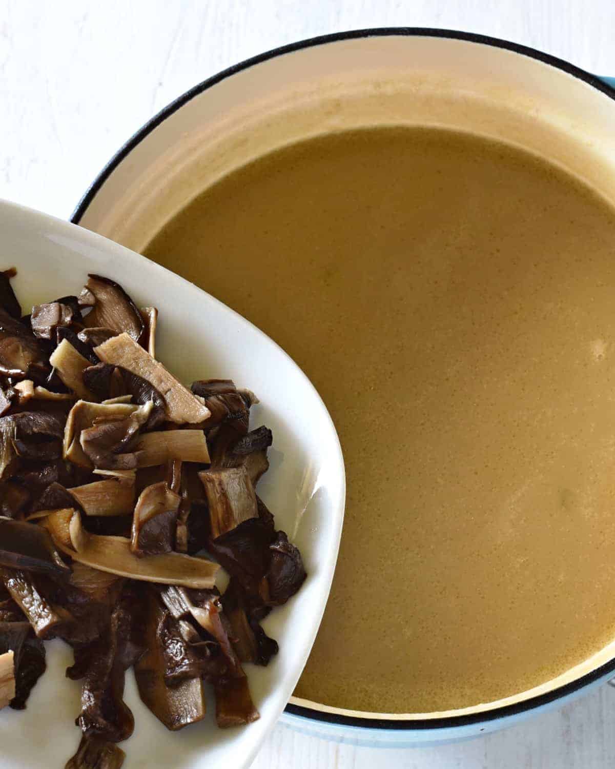 adding mushrooms to kulajda soup