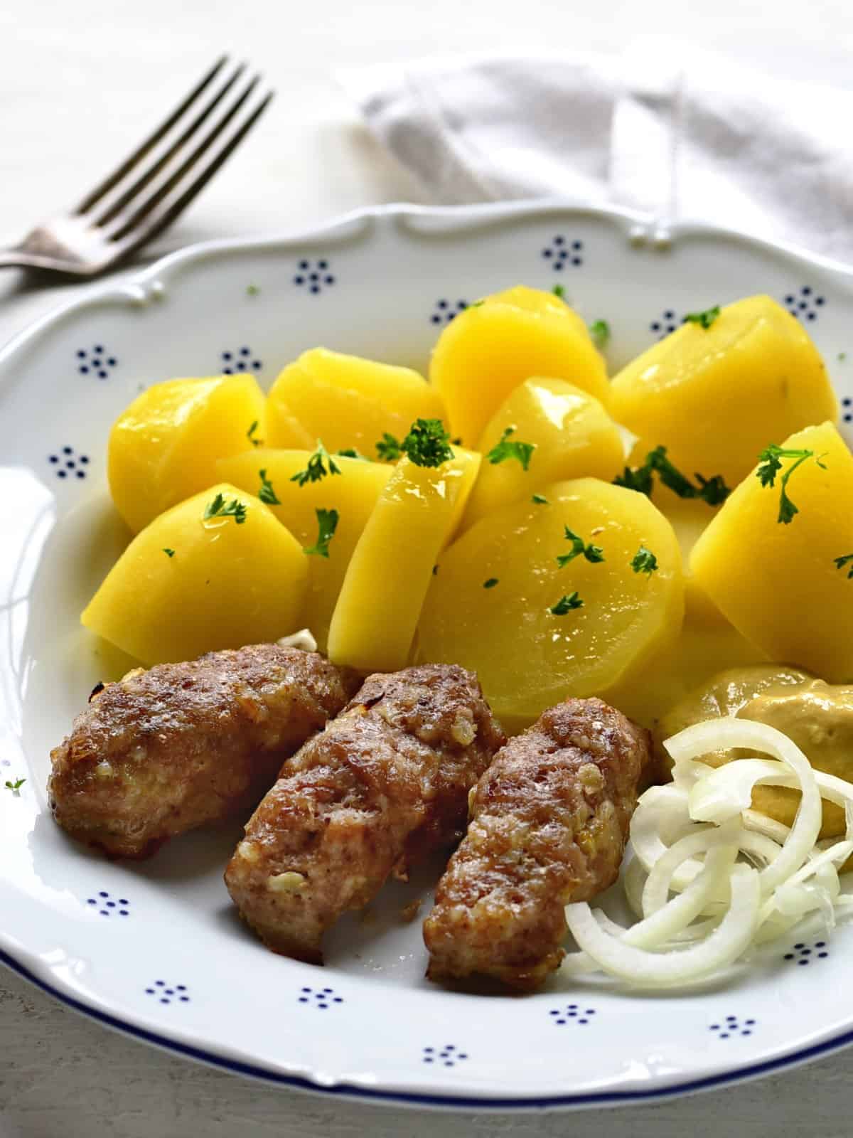 cevapcici served with boiled potatoes