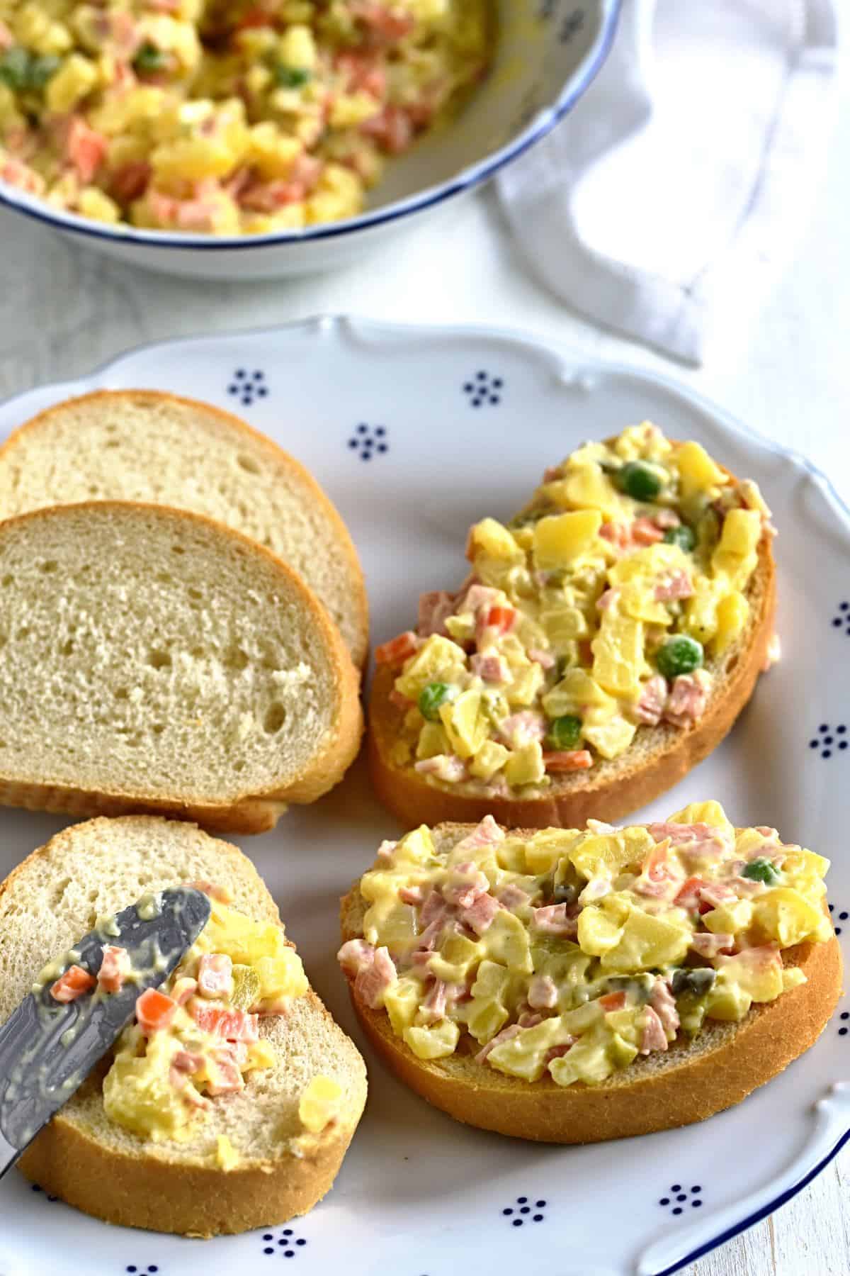 spreading vlašský salát on white bread