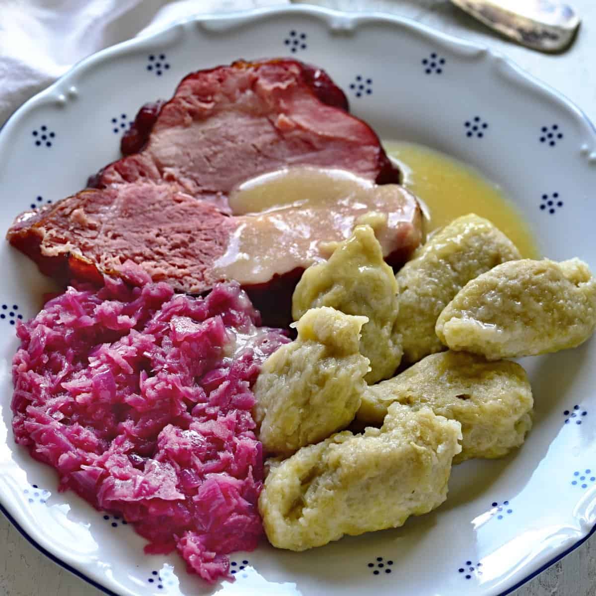 czech chlupaté knedlíky served with smoked meat and red cabbage