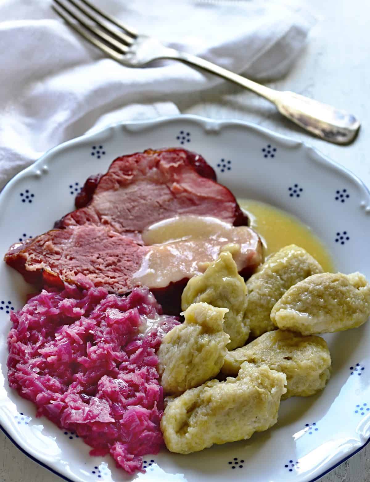 czech chlupaté knedlíky potato dumplings served with red cabbage and smoked meat