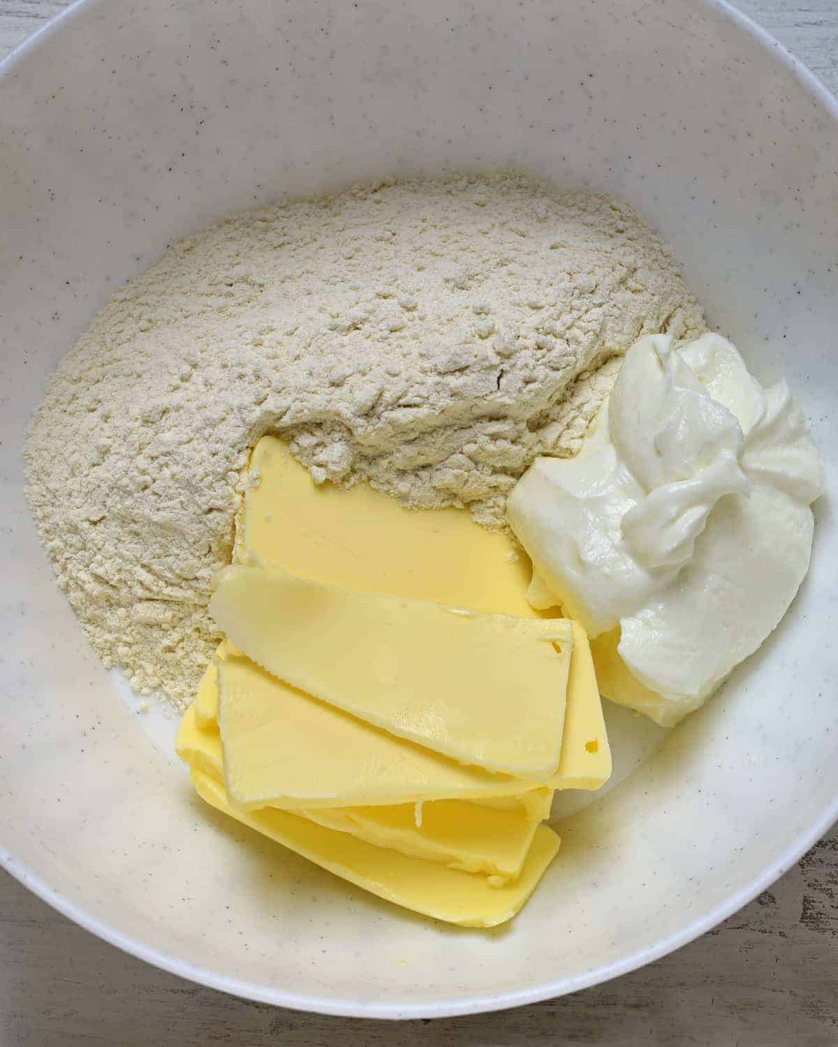 making kolacky dough from cream cheese, flour and butter.