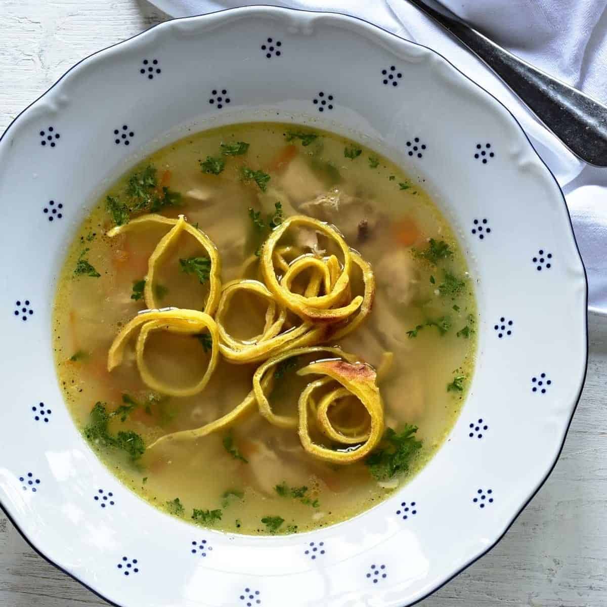 A clear soup served with celestýnské nudle (noodles).