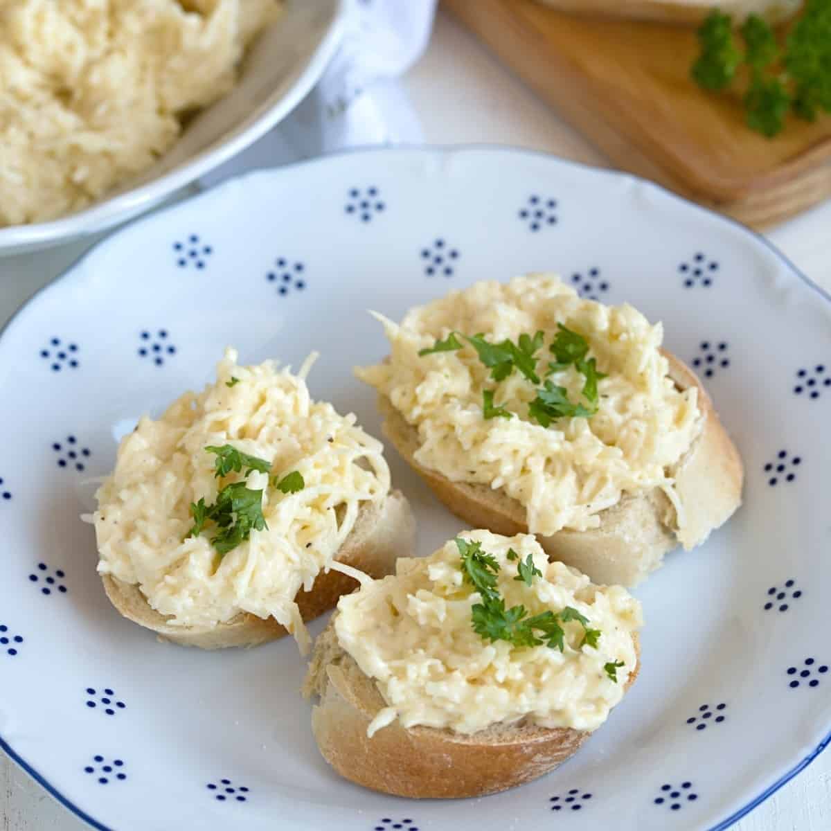Czech style garlic cheese spread served on white bread, sprinkled with green parsley. 